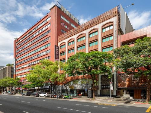 a tall red brick building on a city street at Guide Hotel Taipei Fuxing North in Taipei