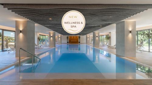 a swimming pool in a building with a large ceiling at Remisens Hotel Albatros-All inclusive in Cavtat