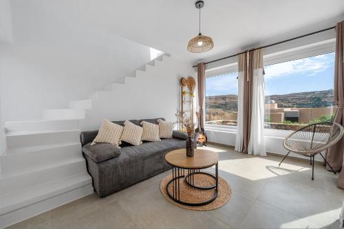 a living room with a couch and a table at The Aer Element Of Gaea in Loutrá