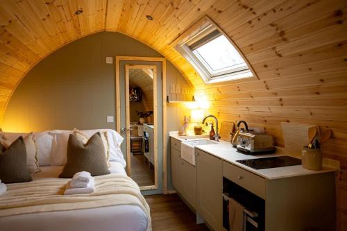 a kitchen with a bed and a sink in a room at The Fox at Snowhill Glamping in Scorton