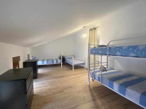 a room with two bunk beds and a desk at Casa Rural Boni in Fuentemolinos