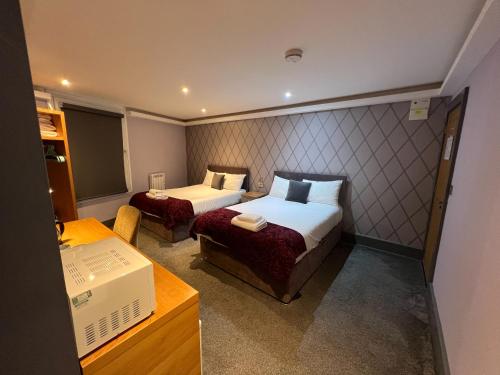 a hotel room with two beds and a desk at Fountain House in Boston