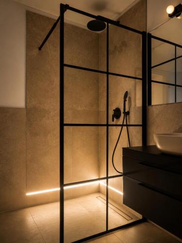 a bathroom with a glass shower with a sink at Apartments Villa Klaudia in Crikvenica