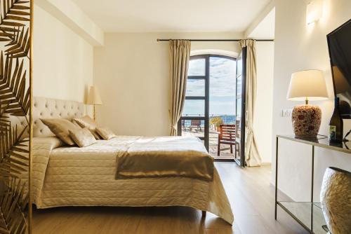 a bedroom with a large bed and a balcony at Miramare Apartments&Suites in La Spezia