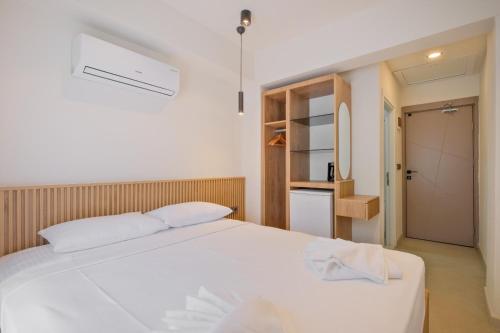 a bedroom with a white bed and a closet at Miralya Downtown in Fethiye