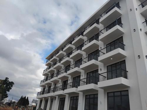 a white building with balconies on the side of it at Pinewood Dalat in Da Thien