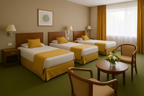 a hotel room with two beds and a chair at Resort Klewinowo in Klewinowo