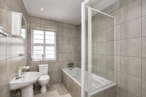 a bathroom with a sink and a toilet and a shower at Jacobsdaller #2 in Jacobs Bay