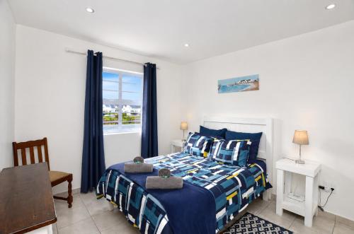 a bedroom with a bed and a window at Jacobsdaller #2 in Jacobs Bay