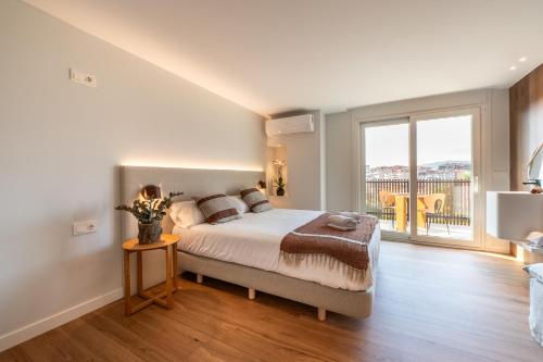 a bedroom with a bed and a large window at Hotel Gamongoa in Rentería