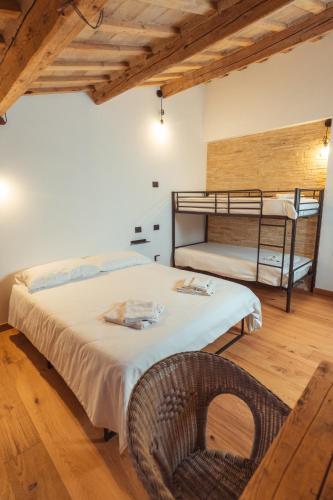 a bedroom with two bunk beds and a chair at Tenuta del Picchio in Colombara