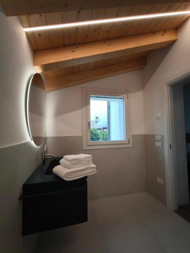 a bathroom with a black sink and a window at L'Albero del Tempo in Falze