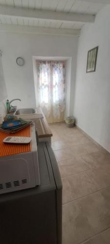a kitchen with a counter and a table in a room at La Bella e La Bestia in Lierna