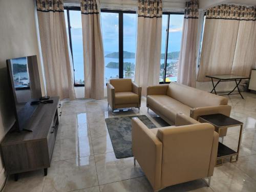 a living room with a couch and a television at Entre Ciel et Lagon in Mtsamboro