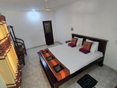 a bedroom with a bed in a room at Hotel Tree Garden Wilpaththu Nochchiyagma Anuradhapura in Nochchiyagama
