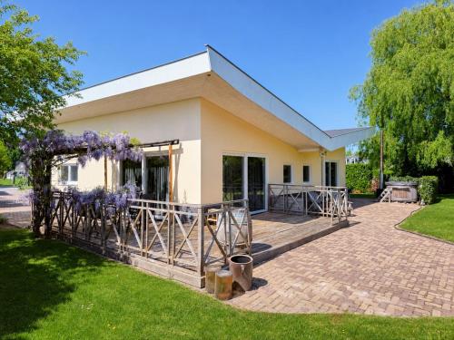 a house with purple wreaths outside of it at Villa Vera - Comfort, Space, Sauna & Hot Tub in Private Garden in Zeewolde