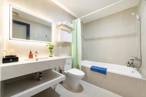 a bathroom with a sink and a toilet and a bath tub at Ngan Ha Hotel - Ben Thanh Central in Ho Chi Minh City