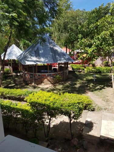 a small hut with a tin roof in a yard at Mbeya Hotel in Mbeya