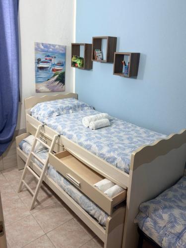 a bedroom with a bunk bed in a room at Da Michele. in Costa Rei
