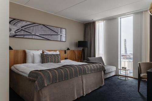 a hotel room with a bed and a large window at Clarion Hotel Malmö Live in Malmö