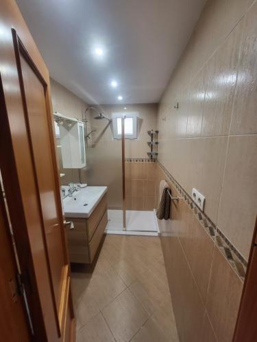 a small bathroom with a sink and a shower at La Casita del Mar in Torrox