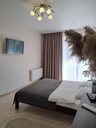 a bedroom with a bed and a large window at ЖК Dream Town, Lutsk in Lutsk