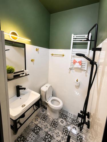 a bathroom with a sink and a toilet and a mirror at The Fireplace ROOM in Borjomi