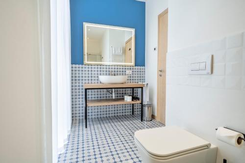 a bathroom with a sink and a toilet at Holiday IV Gardan in Riva del Garda