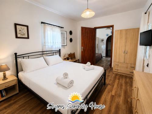 a bedroom with a bed with towels on it at Skyros Serenity House in Skiros