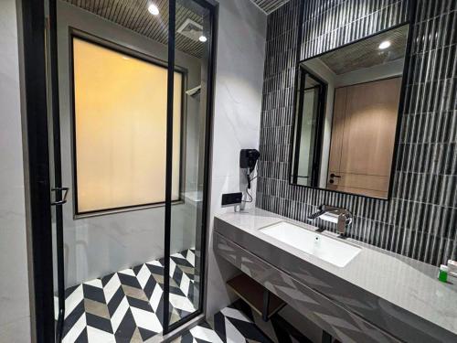 a bathroom with a sink and a mirror at Hotel Grand Parivaar in Igatpuri