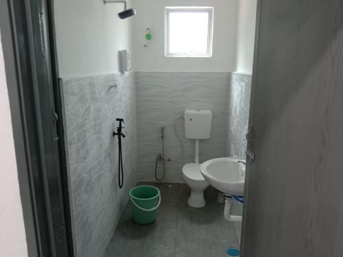 a bathroom with a toilet and a sink at Kenari homestay in Gopeng