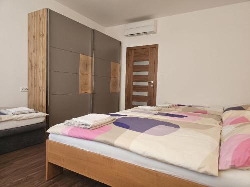 a bedroom with a large bed and a closet at Studio Hálkova in Chlumec nad Cidlinou