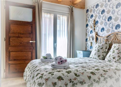 a bedroom with a bed with a stuffed animal on it at La Melosa Cottage in Cudillero