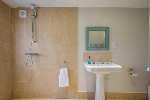 a bathroom with a sink and a shower at Drift Cottage, Rendlesham in Rendlesham