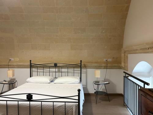 a bedroom with a bed and a brick wall at Ai Foggiali in Matera