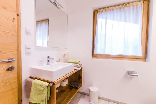 a bathroom with a white sink and a mirror at Praitladhof in Lana
