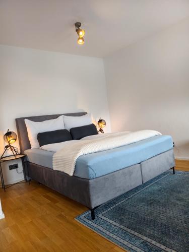 a bedroom with a bed with a blue foot board at Apartment Central Mutters Innsbruck in Innsbruck