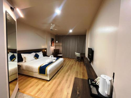 a hotel room with a bed and a mirror at Hotel Cloud by ARIENA in Phundardih
