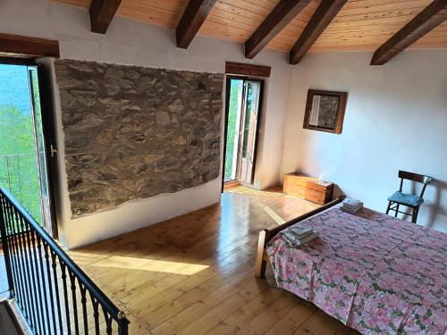 a room with a bed and a stone wall at Cristallo del Gran Sasso in Forca di Valle