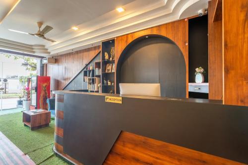 a bar in a room with wooden walls at Treebo Jaguar Comforts, 3 Kms From Mahatma Gandhi Park in Chikmagalūr
