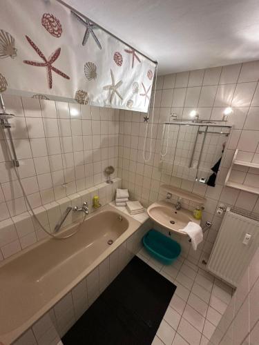 a bathroom with a tub and a toilet and a sink at Haus Hönigsgrub in Rinchnach