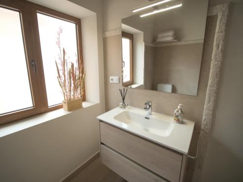 a bathroom with a sink and a mirror at El Passeig Rural in Castalla