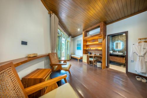 a living room with a wooden ceiling at Nava Luang Prabang Hotel in Luang Prabang