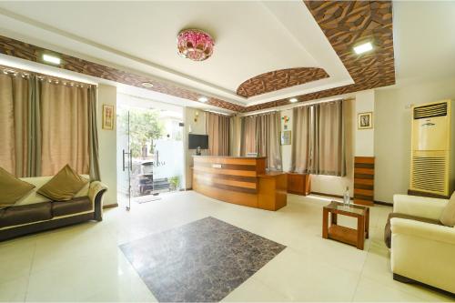 a living room with a couch and a table at FabHotel Aayansh in Jaipur