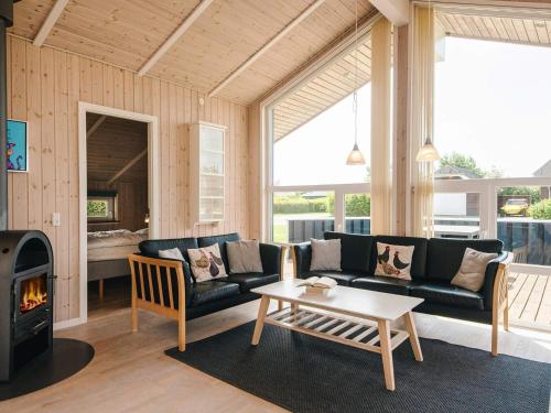 a living room with a couch and a table and a fireplace at 4 star holiday home in Tarm in Tarm
