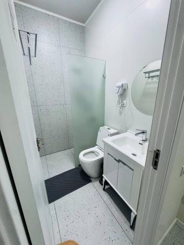 a bathroom with a toilet and a sink and a shower at BOG'DON GRAND Hotel in Tashkent