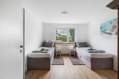 a room with two beds and a window at Apartment Melody in Oberkochen