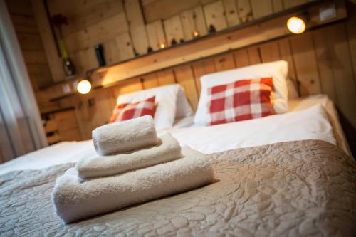a bedroom with a bed with towels on it at Hotel Osrblie in Osrblie