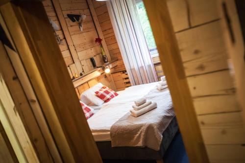 a small room with a bed with two hands on it at Hotel Osrblie in Osrblie