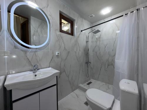 a bathroom with a sink and a toilet and a mirror at Old Town Hostel Gyumri in Gyumri